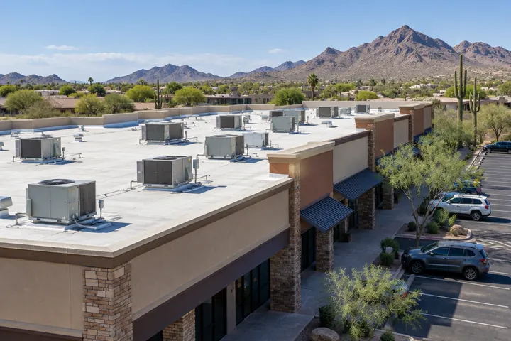 Flat roof over a Scottsdale retail strip with rows of rooftop HVAC units